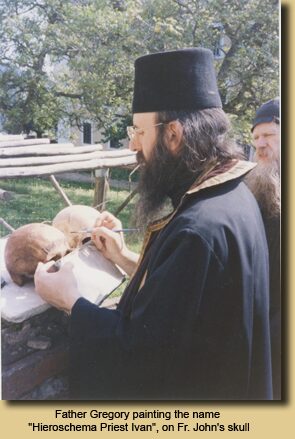 Father Gregory painting the name “Hieroschema Priest Ivan”, on Fr. John’s skull