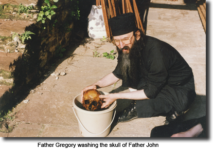 Father Gregory washing the skull of Father John