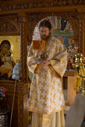 Bishop John receiving the chalice at the Great Entrance.