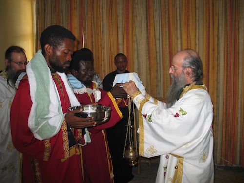 The Great Entrance. The subdeacon who is about to be ordained a deacon holds
    the pitcher and water.