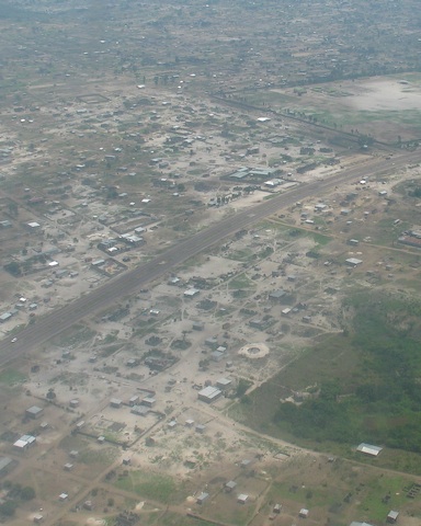 An Aerial Shot of Kinshasa with a paved road down the middle.