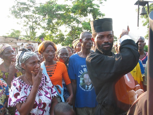 Leaving the Church for a Conference with the Clergy. Notice the two white doves
    Father Theophile is holding, which the people of Kananga offered us as a gesture of
    love.