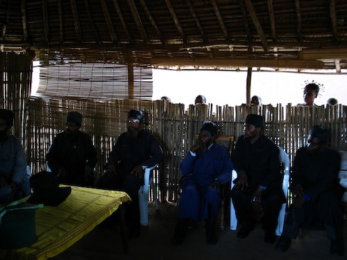 Photograph of the Clergy at the Conference, with lay people outside, listening
    in.