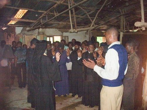 The Clergy with upraised hands, renouncing Cyprianism and Ecumenism.