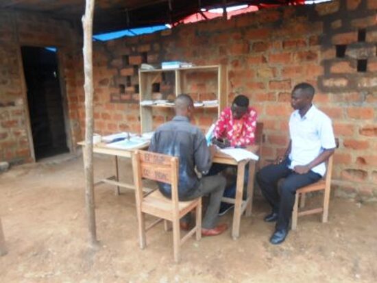Teachers working at tables in an open classroom