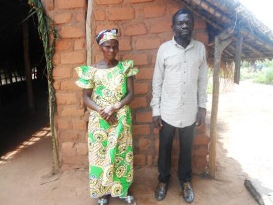 A woman and a man standing by a school building