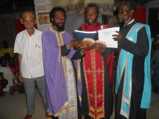 Priests in vestments reading together from service books