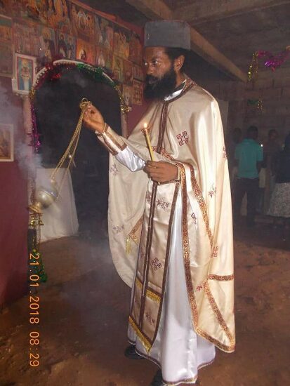 Father Theophile in vestments censing in the church