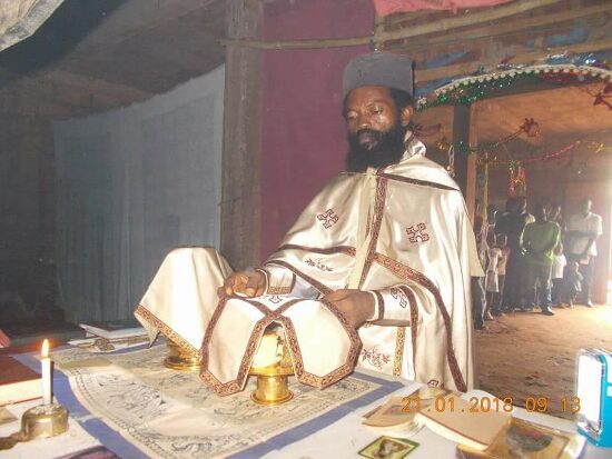 Father Theophile in vestments at the altar table