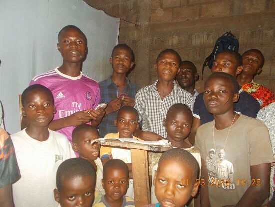 Young people of the parish crowded around a table indoors