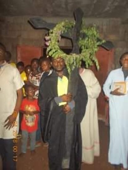 The procession around the church at night, the cross hung with green branches