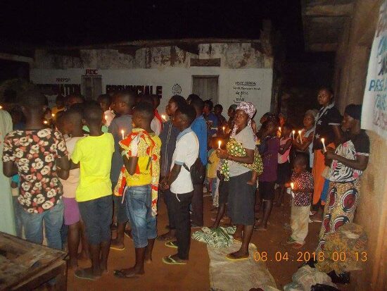 The faithful holding candles in the Paschal procession