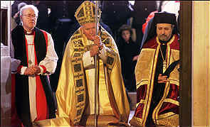 Athanasios,
  Pope John Paul II, and Anglican Archbishop George Carey kneel in common prayer before the
  ‘holy’ doors of the Papal basilica of St. Paul’s Outside the Walls (Rome) as
  part of the Ecumenical concelebration featured on the first day of the Pope’s Jubilee and
  annual “Week of Prayer for Christian Unity” (Tuesday, January 18, 2000). All
  ‘Orthodox’ Patriarchates sent representatives and participated in the service.