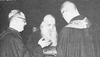 At yet another Ecumenical
  worship service, a Benedictine monk presents Athenagoras with the Cross with which to
  ‘bless’ the monks and laity.