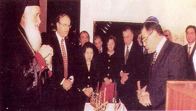 Chrysostom,
  Metropolitan of Kition (Cyprus) participates in a Jewish festival and lights their Menorah.