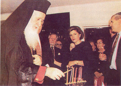 Chrysostom,
  Metropolitan of Kition (Cyprus) participates in a Jewish festival and lights their Menorah.